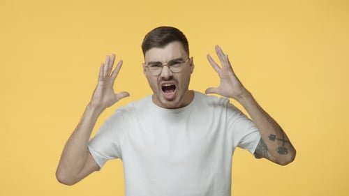 Man Shouts in Frustration on Yellow Background