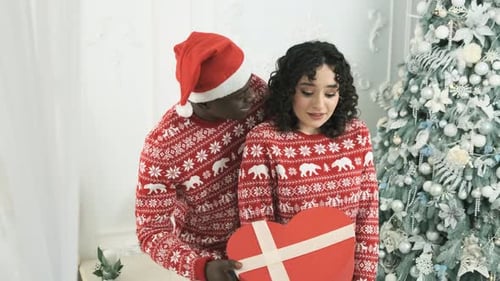 Man Gives Woman Heart Gift at Christmas