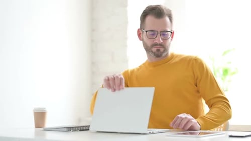 Man Working on Laptop Closes it and Leaves
