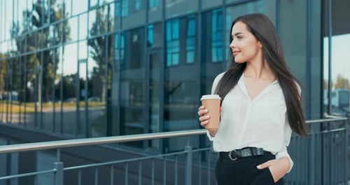 Beautiful Cheerful Woman Working in an Office Corporation Company Dressed in Elegant Clothes Walks