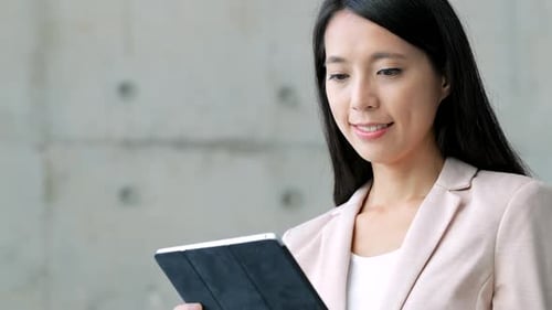 Young Woman Working on Tablet in Modern Office