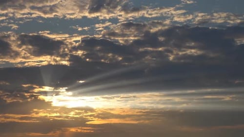 Rays of Light Shine Through Cloudy Sunset