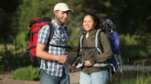 Happy Couple with Backpacks in Nature