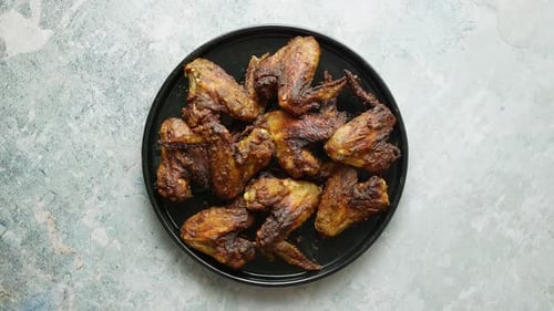 Delicious Crispy Chicken Wings on Plate Overhead