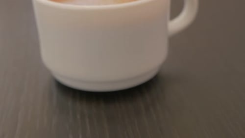 Coffee in a White Cup on Wooden Table