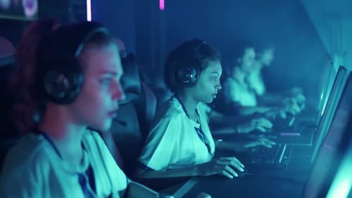 Young Adults Playing Video Games in Neon Room