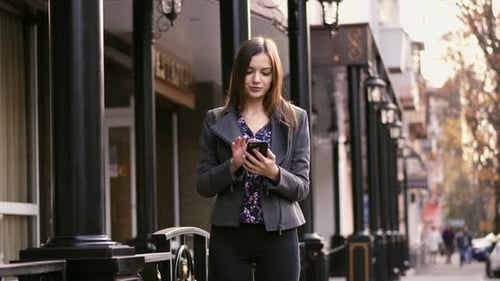 Beautiful Businesswoman on Street Using Smartphone App, Surfing Internet and Smile Slow Motion