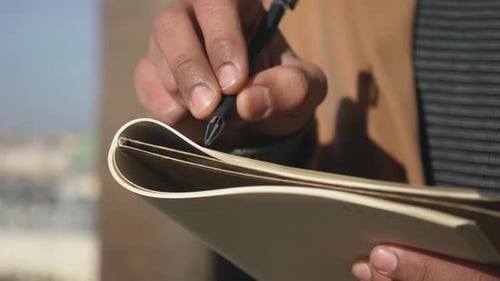 Hand Writing in Notebook With Pen Close Up