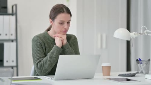 Young Woman Thinking Using Laptop