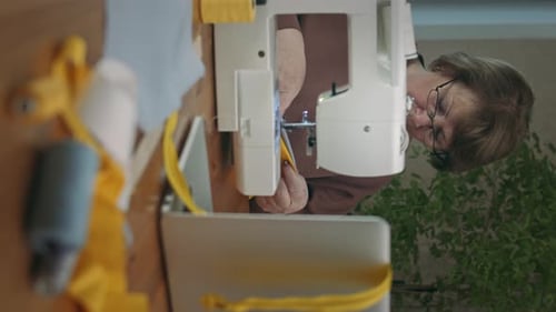 Woman Sewing Fabric with a Sewing Machine