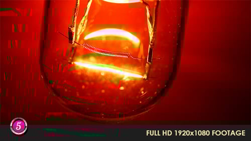 Glowing Light Bulb Filament on Red Background