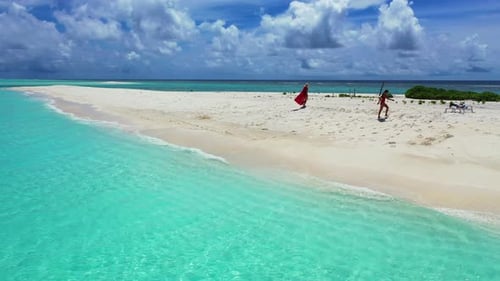 Young happy ladies on vacation enjoying life at the beach on sunny blue and white sand background 4K