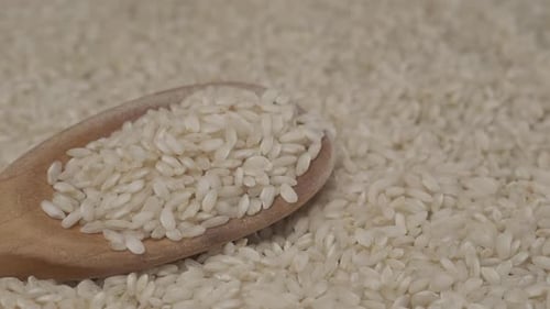 Close Up of White Rice with Wooden Spoon