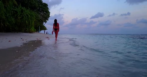 Sexy beauty models on photoshoot having fun on the beach on paradise white sand and blue background