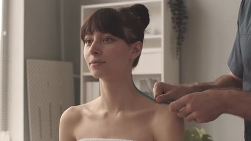 Healthcare Professional Measuring Woman for Kinesiology Tape