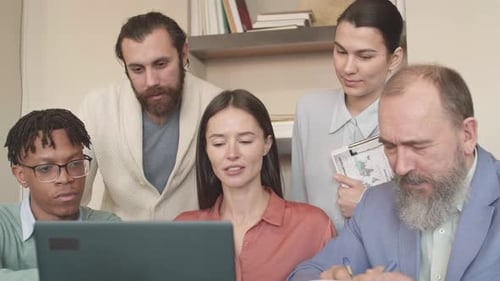 Diverse Team Collaborates at Office Desk