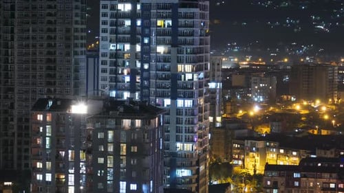 Multistorey Buildings with Changing Window Lighting At Night in City, Timelapse