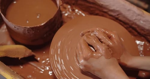 Hands Working with Clay on Pottery Wheel