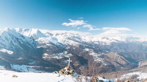 Panorama from summit on snow capped mountain peaks and ridges of the Alps