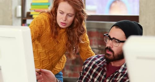 Teamwork: Adults Collaborating at Computer in Office