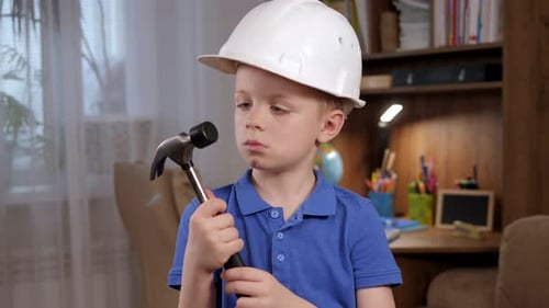 Young Boy with Hammer and Hard Hat