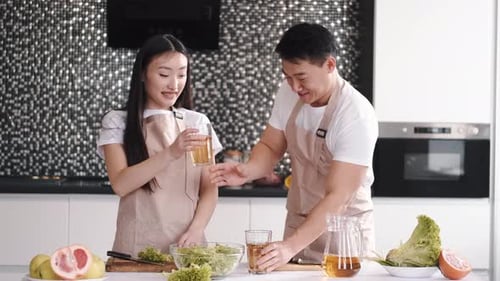 Cheerful Couple Cooking Together in Modern Kitchen