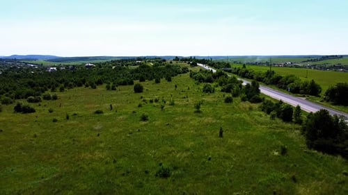 Aerial drone view of a flying over the rural agricultural landscape.