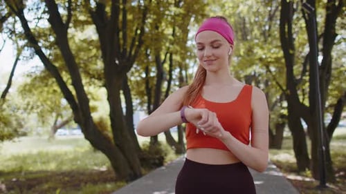 Active Woman Using Smart Watch in Park