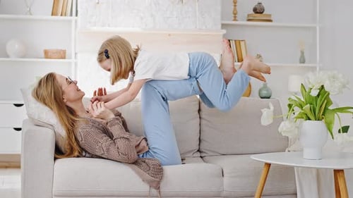 Mother and Child Playing Together on Couch