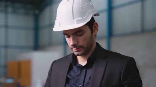 Factory Manager Using Tablet Computer in Warehouse or Factory