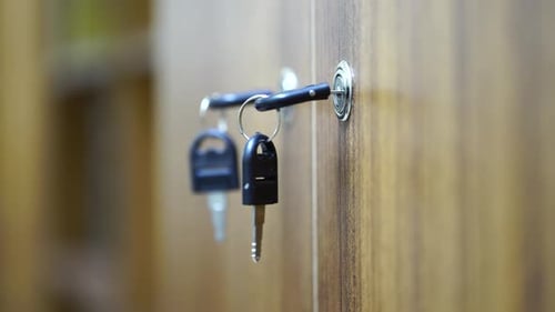 Keys Hanging from a Cabinet Keyhole Close Up