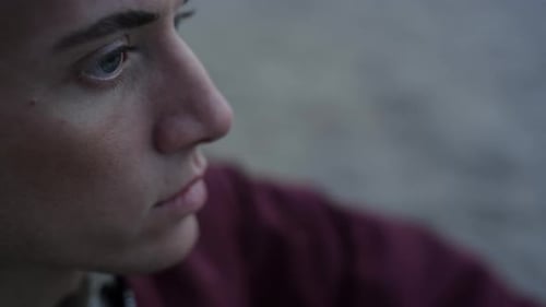 Closeup Serious Man Sitting on Beach