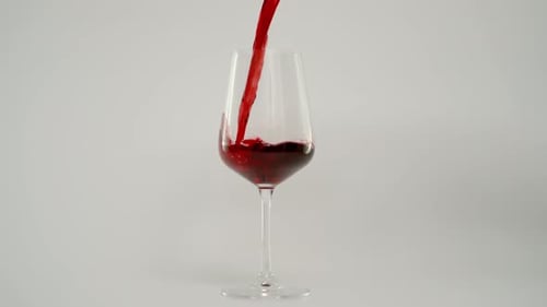 Bright Red Wine Pouring into a Wine Glass