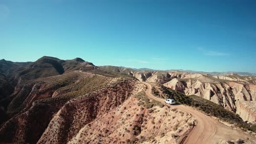 Aerial Shot of Camping Van on Gravel Mountain Road