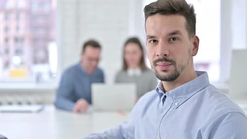 Serious Creative Man Looking at the Camera in Office