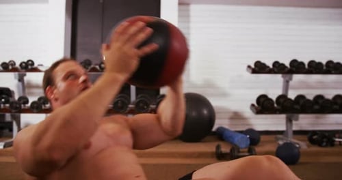 Man doing crunches with ball