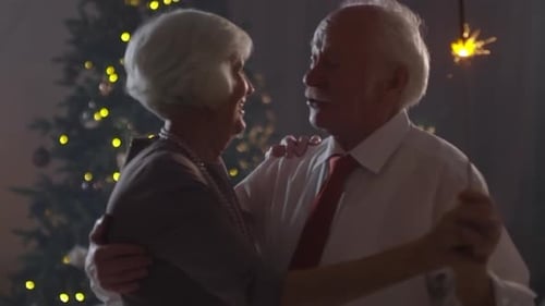 Senior Couple Dancing with Sparklers at Christmas