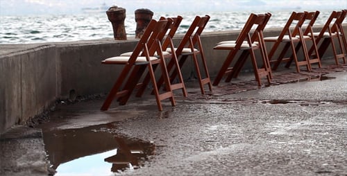 Row of Empty Wedding Chairs Next to Ocean