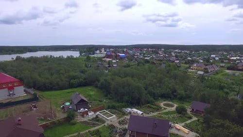 Aerial view of village with a church by the pond. 01