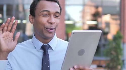 Young Man Video Chatting on Tablet Device