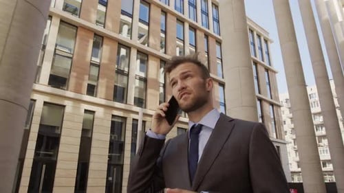 Smiling Businessman Talking on Phone Outdoors