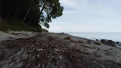 Drone Shot of Sandy Shores and Vast Ocean Waters Under Blue Sky