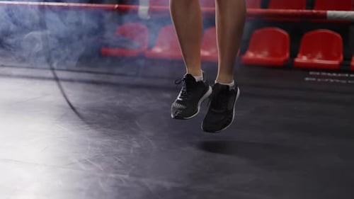 Close Up of Young Female s Legs Boxer Jumping on the Skipping Rope on Ring
