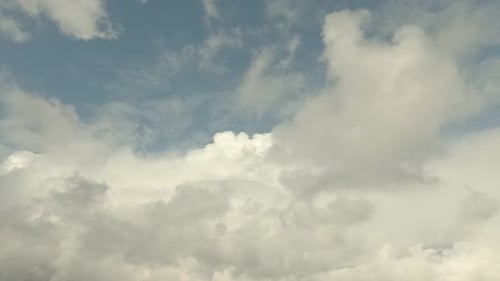 Clouds Sweep Across a Pale Blue Sky