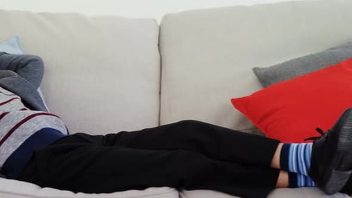 Smiling Blond Boy Lies Talking on Mobile Phone