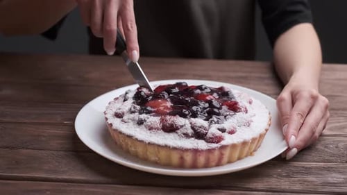 Cutting Delicious Berry Tart with Knife