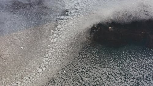 Stones in the Sea About Which the Sea with Ice Floes Splashes