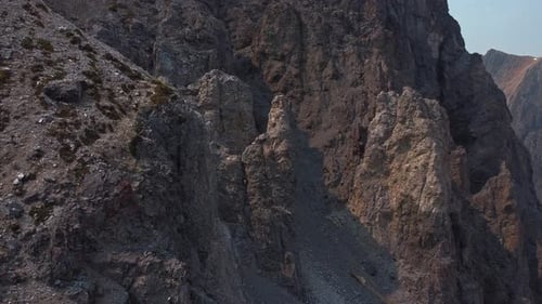 Rock formation in mountain range with pan on a sunny day