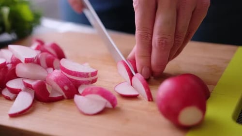 Radishes Being Sliced with a Knife