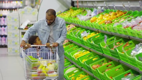 Father and Son Pushing Shopping Cart